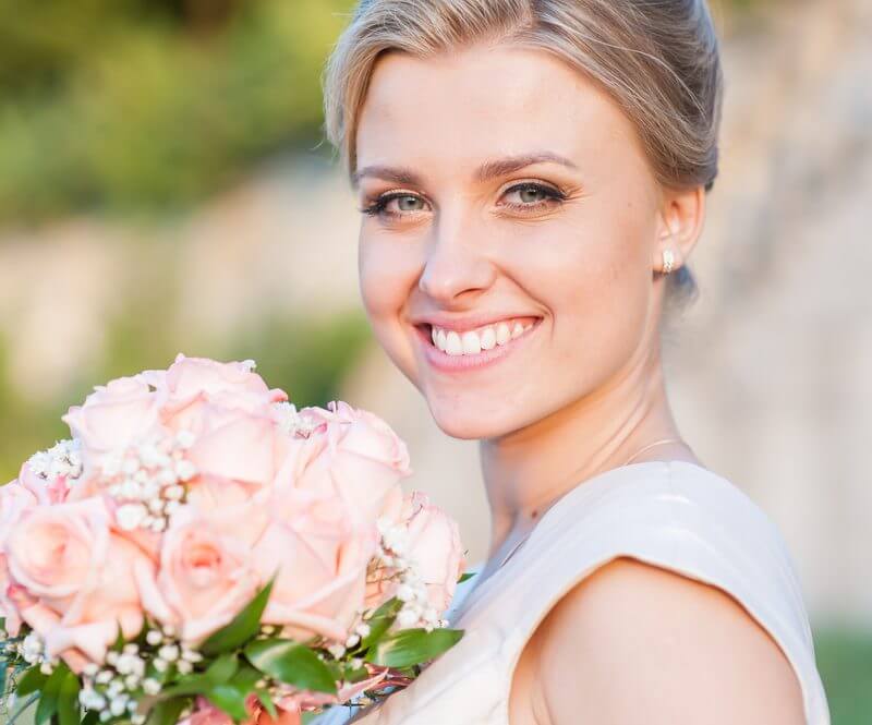 Bride Smiling Holding Flowers