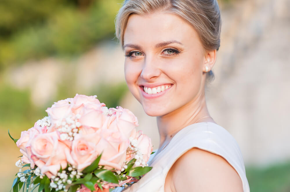 Bride Smiling Holding Flowers