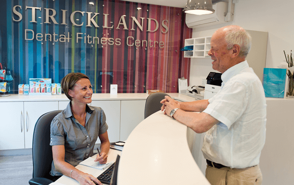 Stricklands Receptionist Interacting with Patient