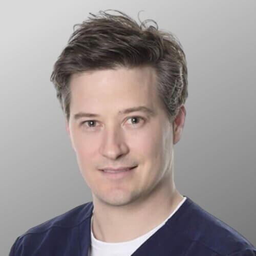 young man blue overalls professional headshot